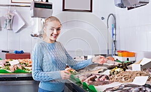 Woman selecting fish at fishery