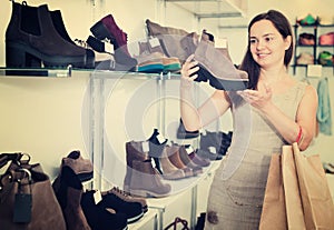 Woman selecting loafers in footgear center