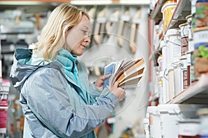 Woman selecting paint at hardware store photo