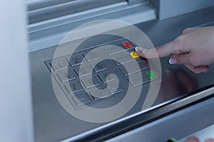 Woman selecting a transaction on a bank ATM