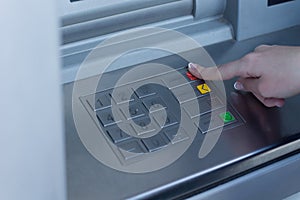 Woman selecting a transaction type on the bank ATM