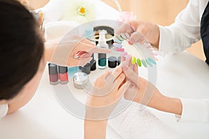 Woman selects color shellac nail polish
