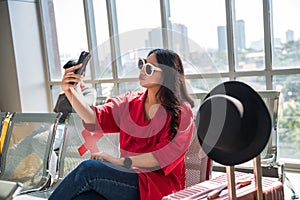 woman selfie in airport terminal wait to departure