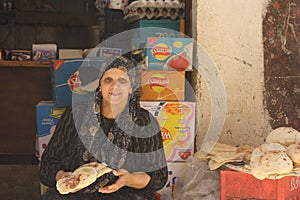 Woman selling bread in Kafr Ghataty