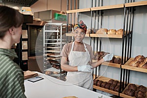 Woman selling the bread in the store