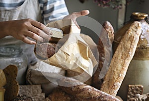 Woman selling cheese to a customer at a farm shop