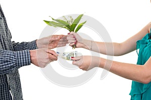 Woman selling flowers to a man, he gives her money