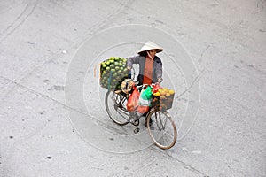 Woman selling fruits on street in Hanoi