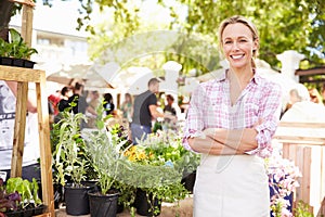 Woman Selling Herbs And Plants At Farmers Food Market