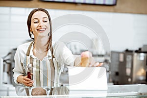 Woman selling ice cream in the shop