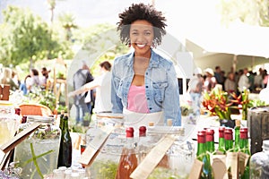 Woman Selling Soft Drinks At Farmers Market Stall