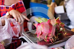 Woman sells dragon fruit on market