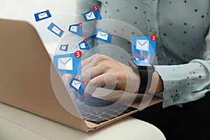 Woman sending emails at table, closeup