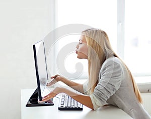 Woman sending kisses with computer monitor