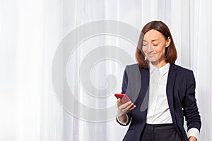 Woman sending message or chatting on smartphone