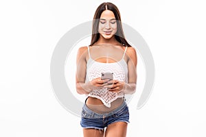Woman sending a sms on cell phone on white background