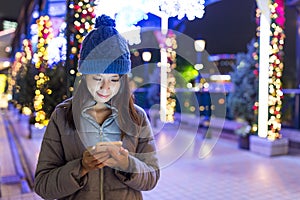 Woman sending sms on mobile phone