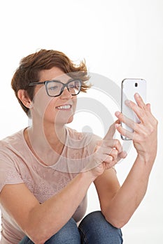 Woman sending text from smart phone.