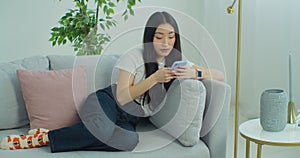 Woman sending voice message using mobile phone. Young Asian girl talk with virtual digital voice recognition assistant