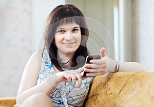 Woman sends SMS by mobile