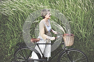 Woman Senior Bicycle Carefree Freshness Peaceful Concept photo