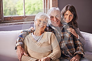 Woman, senior parents and portrait on sofa with hug, smile and connection with care, love and bonding. Old couple