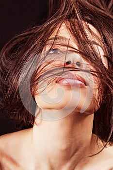 Woman with sensual lips and hair in motion