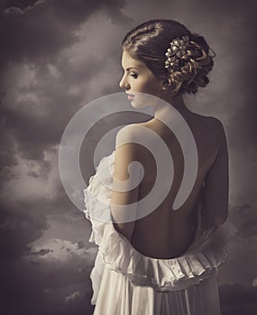 Woman fashion dress, retro hair style, naked back, historical romance portrait