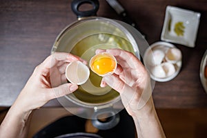 Woman separate egg yolks and whites for culinary