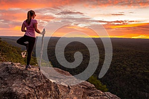 Woman serenity yoga while watching magnificent sunset