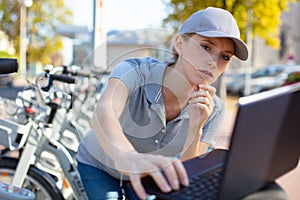 woman servicing public rental bicycles station