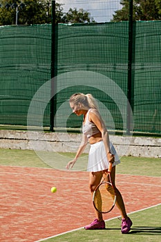 Woman serving the ball for a game of tennis on court