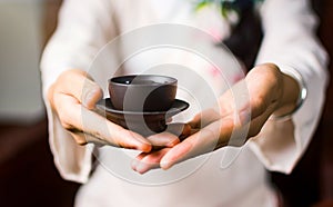 Woman serving Chinese tea in a tea ceremony