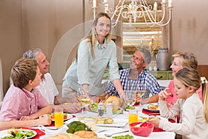 Woman serving christmas dinner to her family