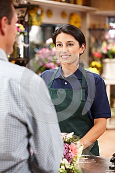 Woman serving customer in florist