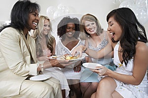 Woman Serving Dessert To Female Guests At Bridal Shower