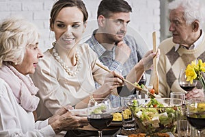 Woman serving dinner to her family