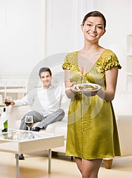 Woman serving elegant dinner to husband