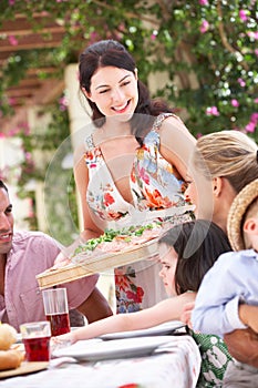 Woman Serving At Family Meal