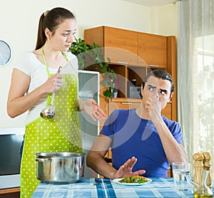 Woman serving food her man at table