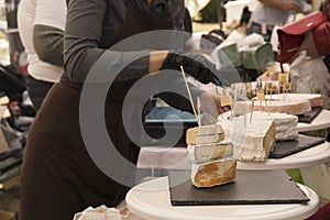 Woman Serving Fresh Cheese At Farmers Food Market