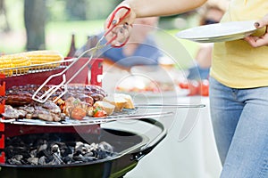 Woman serving grilled steak