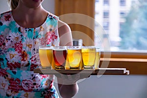 A woman serving holding beer trays