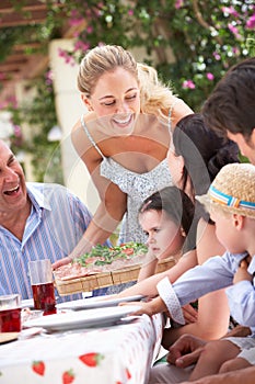 Woman Serving At Multi Generation Family Meal