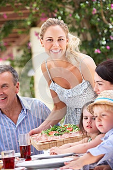 Woman Serving At Multi Generation Family Meal