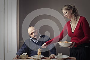 Woman serving pasta to husband