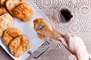 Woman serving Turkish pisi halka or fried dough photo