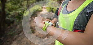 Woman set the sports watch before trail running