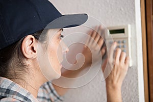 woman set thermostat at house