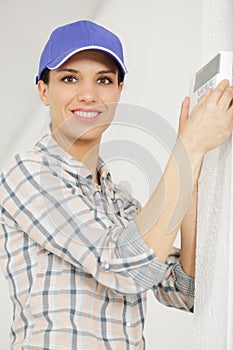 woman set thermostat at house